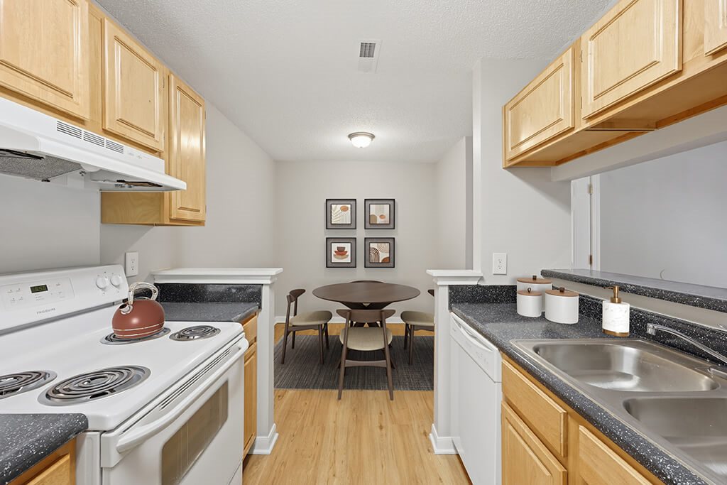 Kitchen with light wood cabinets at Greens of Pine Glen in Durham NC